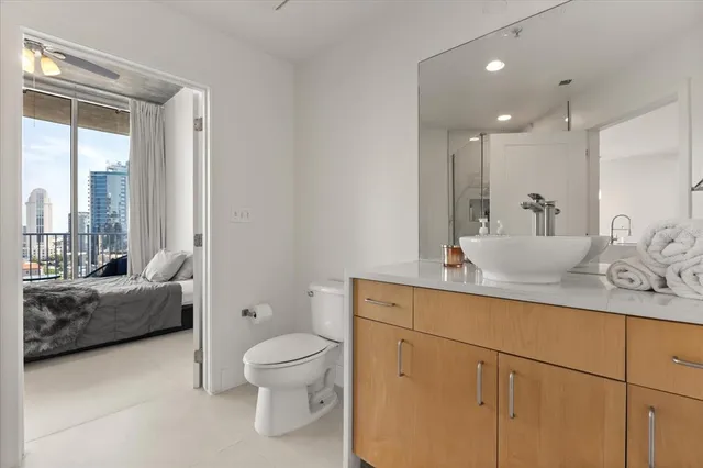 a bathroom with a toilet a sink and glass door