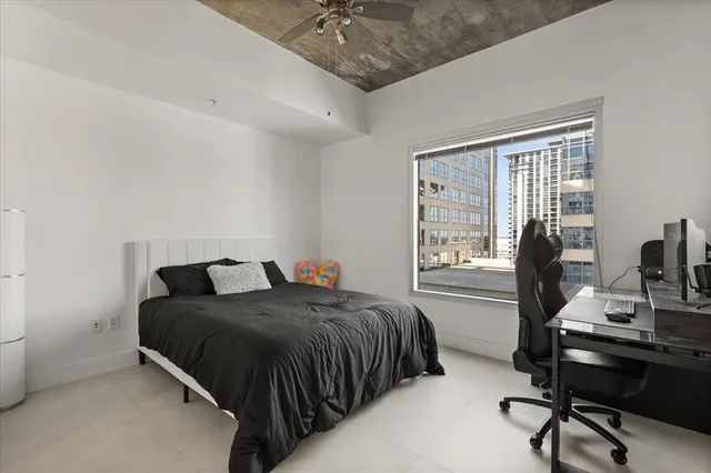 a bedroom with a bed and a desk