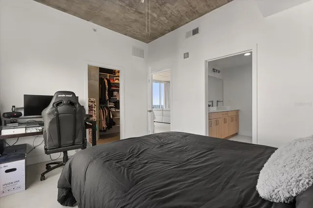 a bedroom with a bed and a television