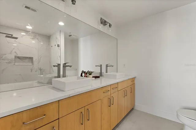 a bathroom with a granite countertop sink mirror and double