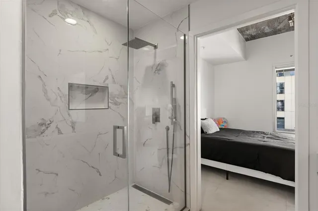 a bathroom with a double vanity sink and shower