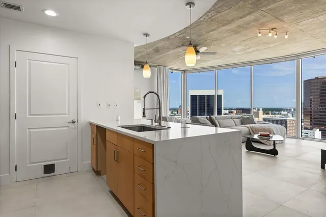 a kitchen with stainless steel appliances a sink stove and cabinets
