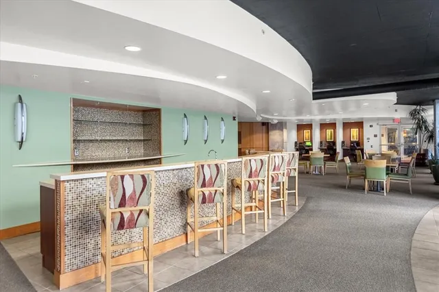 a view of a hallway with furniture and chandelier