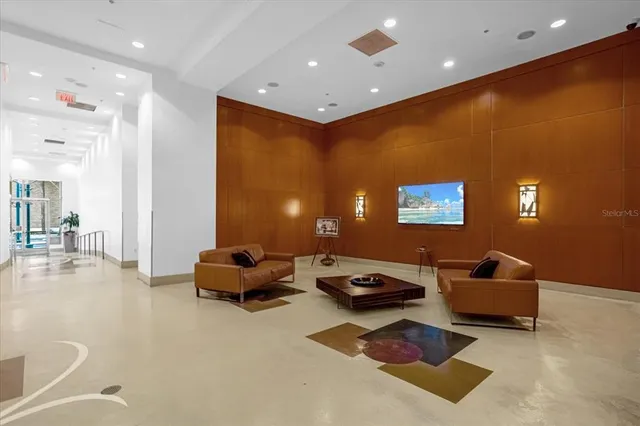 a living room with furniture and a potted plant