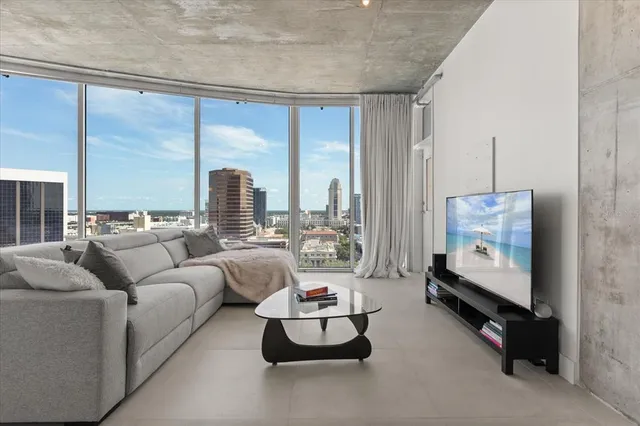 a living room with furniture and a large window