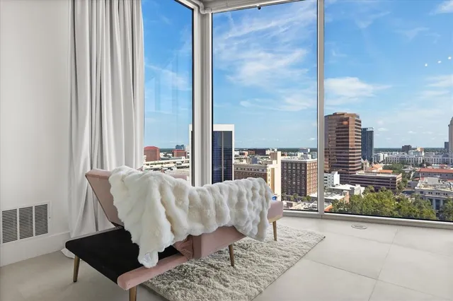 a living room with furniture and a floor to ceiling window