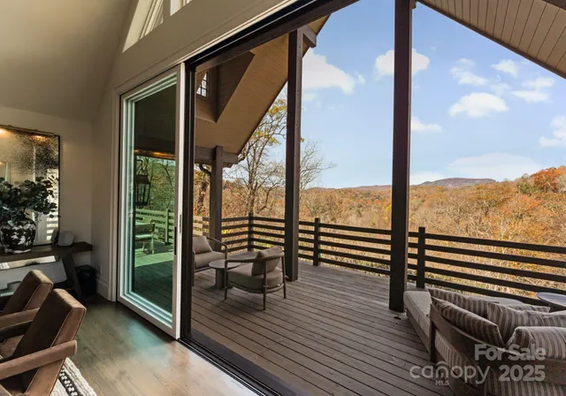 a view of a balcony with floor to ceiling windows with wooden floor