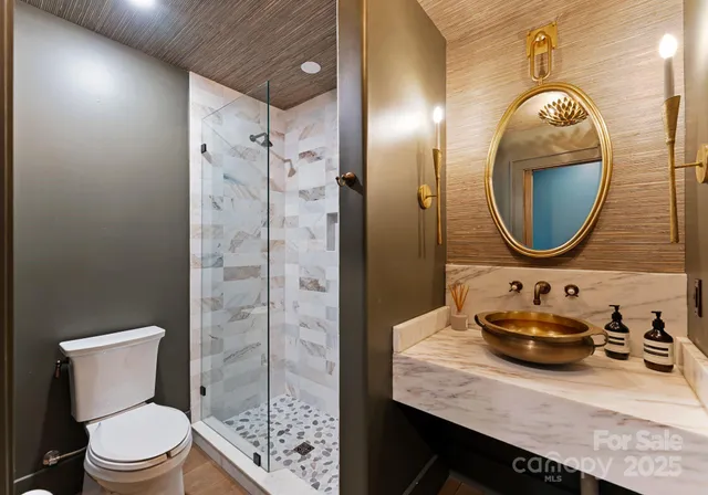 a bathroom with a sink mirror and toilet