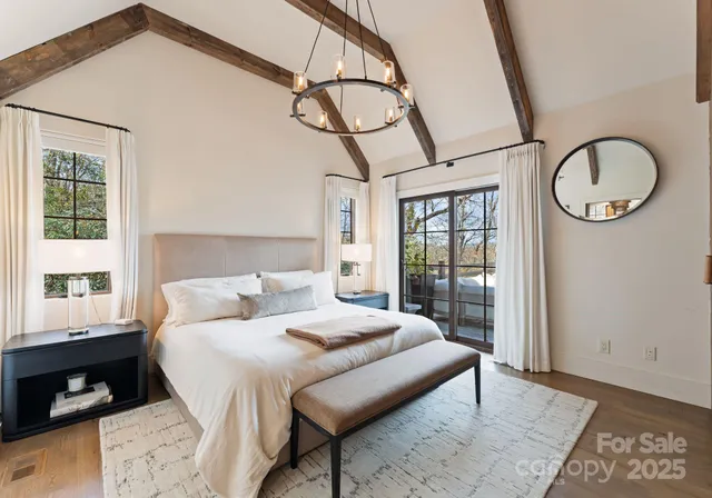 a bedroom with a bed a mirror and a window