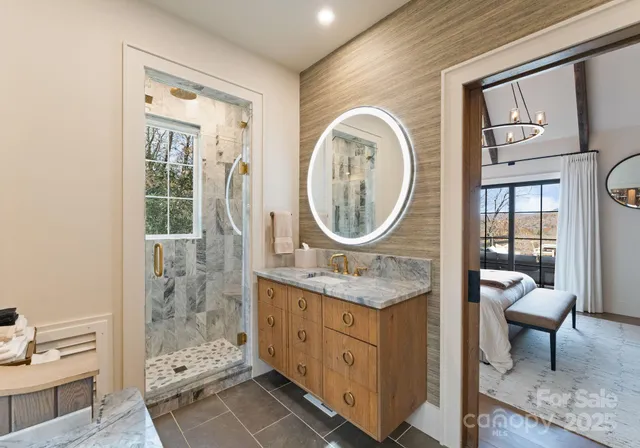 a bathroom with a granite countertop sink a mirror and a shower