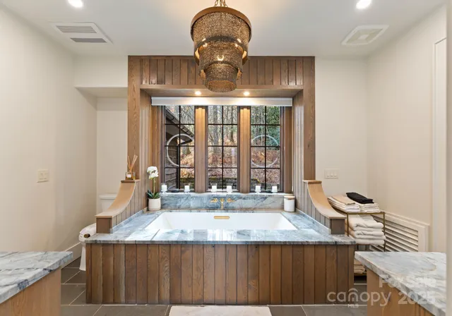 a view of a kitchen with a sink and chandelier