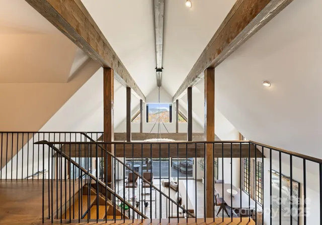 a view of staircase with railing and white walls