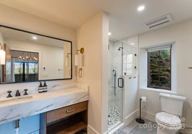 a balcony with wooden floor table and chairs