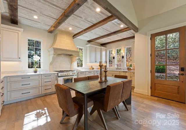 a kitchen with a table chairs sink and cabinets