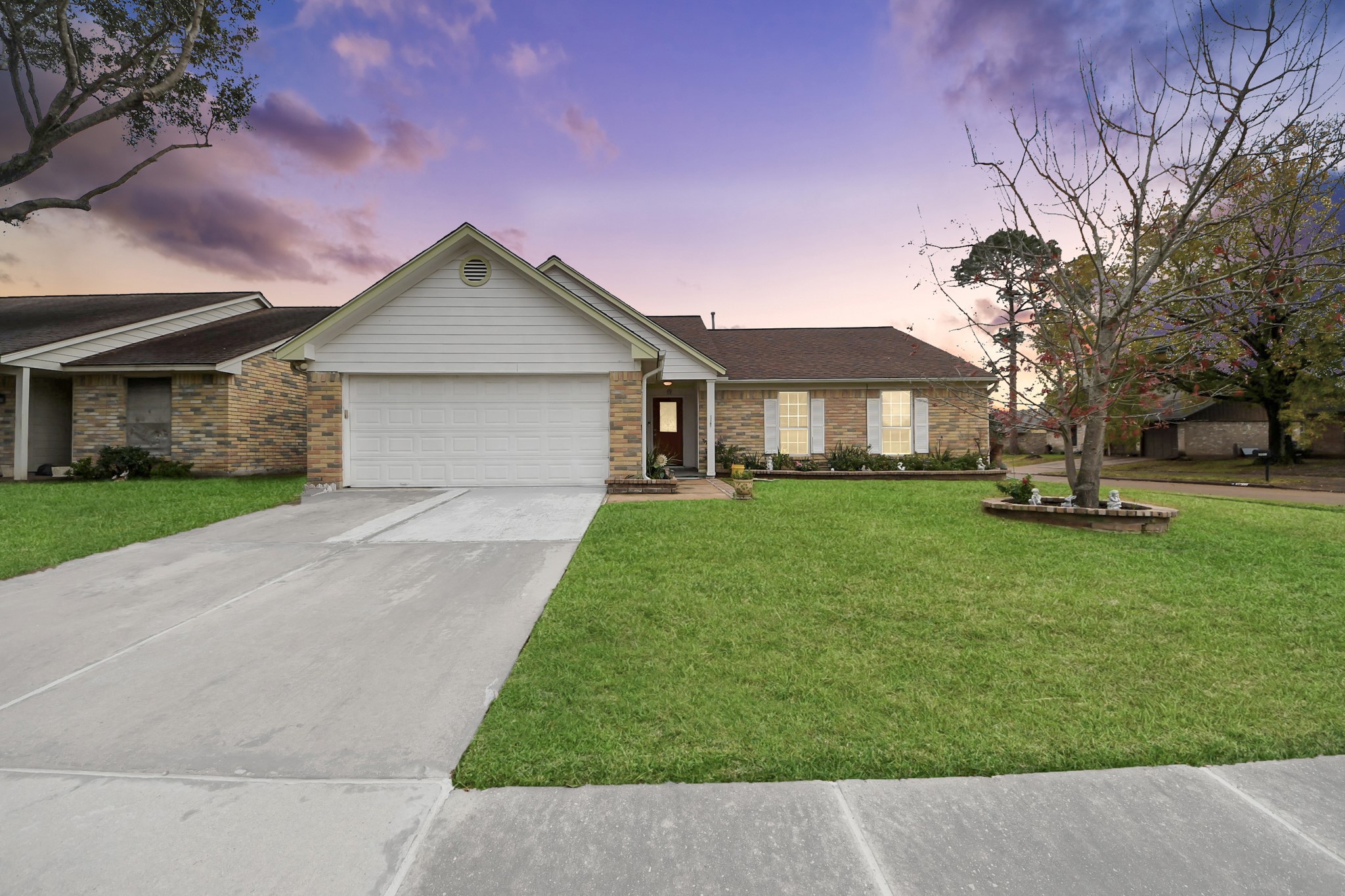 17702 Poppy Trails Lane Houston, TX 77084 - Photo 1 of 37 a front view of a house with a garden and trees