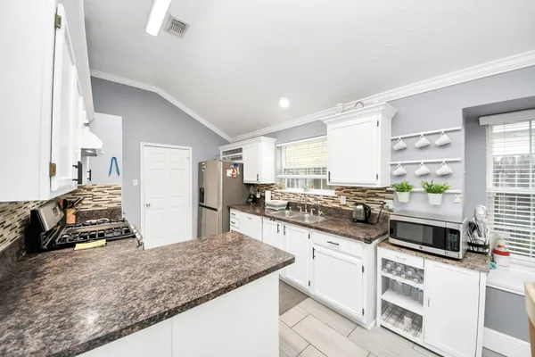 a kitchen with stainless steel appliances granite countertop a stove and a sink