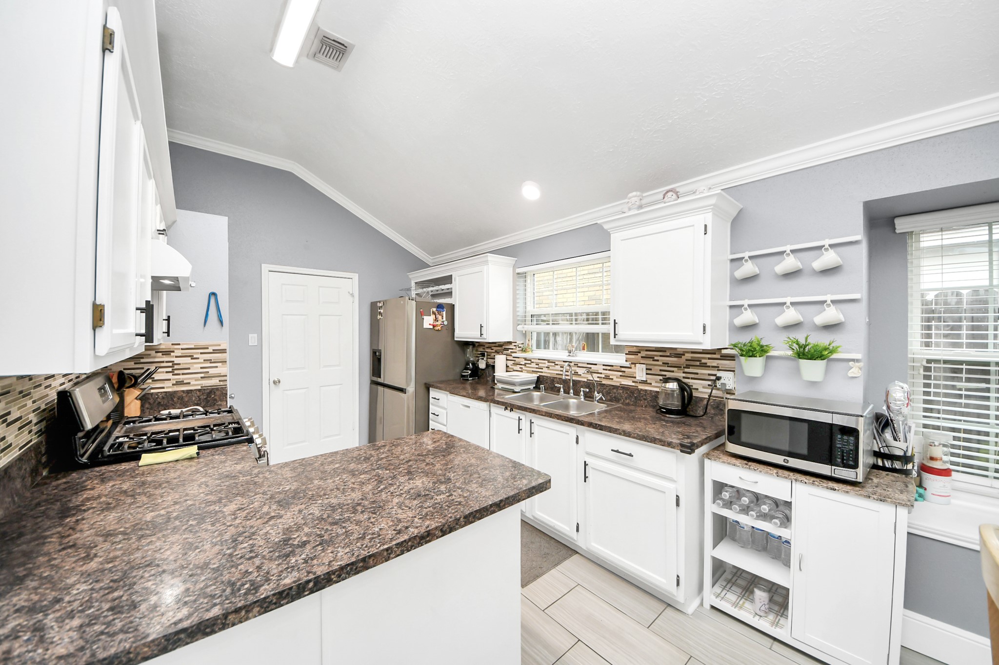 17702 Poppy Trails Lane Houston, TX 77084 - Photo 14 of 37 a kitchen with stainless steel appliances granite countertop a stove and a sink