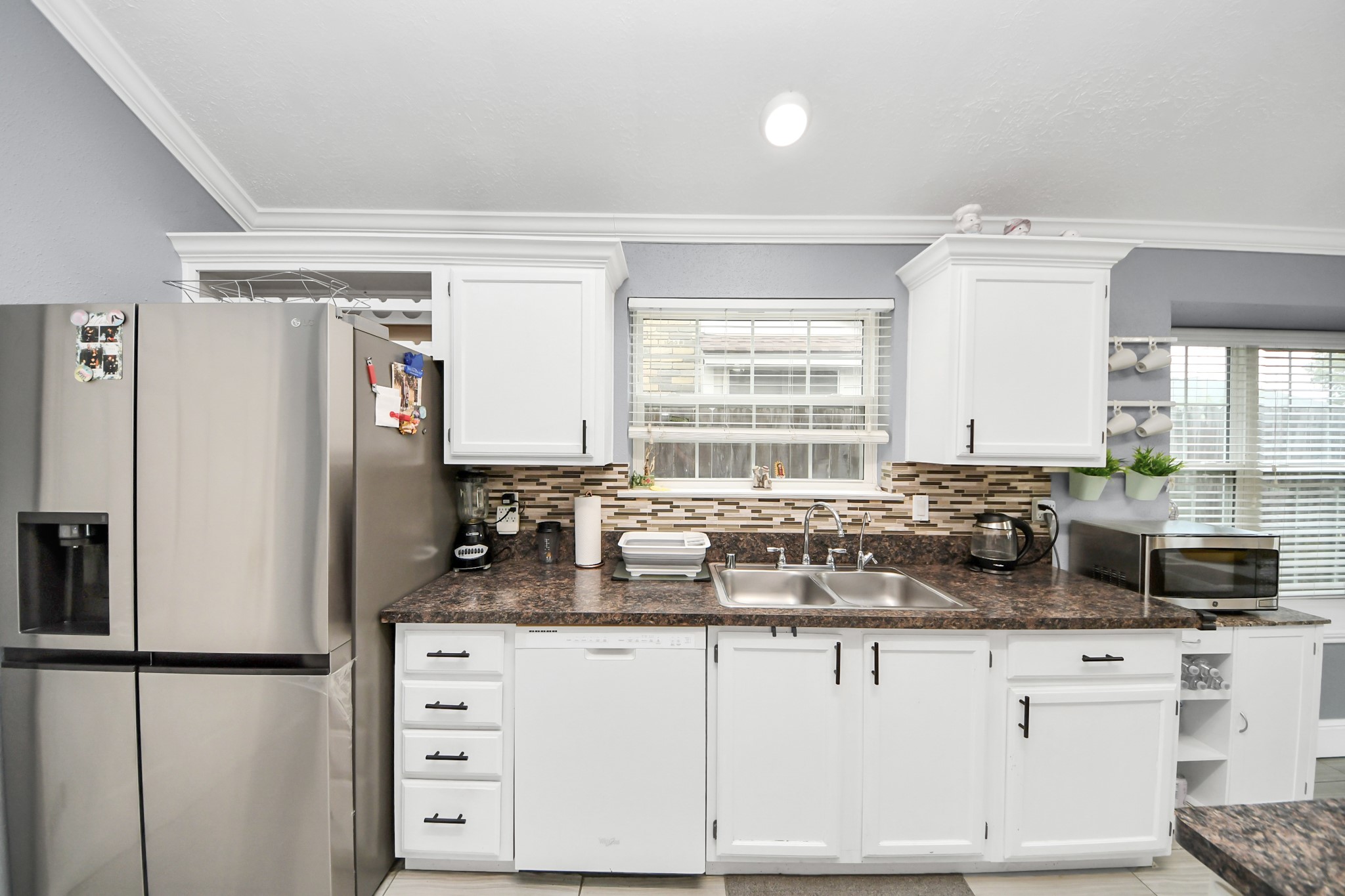 17702 Poppy Trails Lane Houston, TX 77084 - Photo 17 of 37 a kitchen with granite countertop a sink cabinets and window