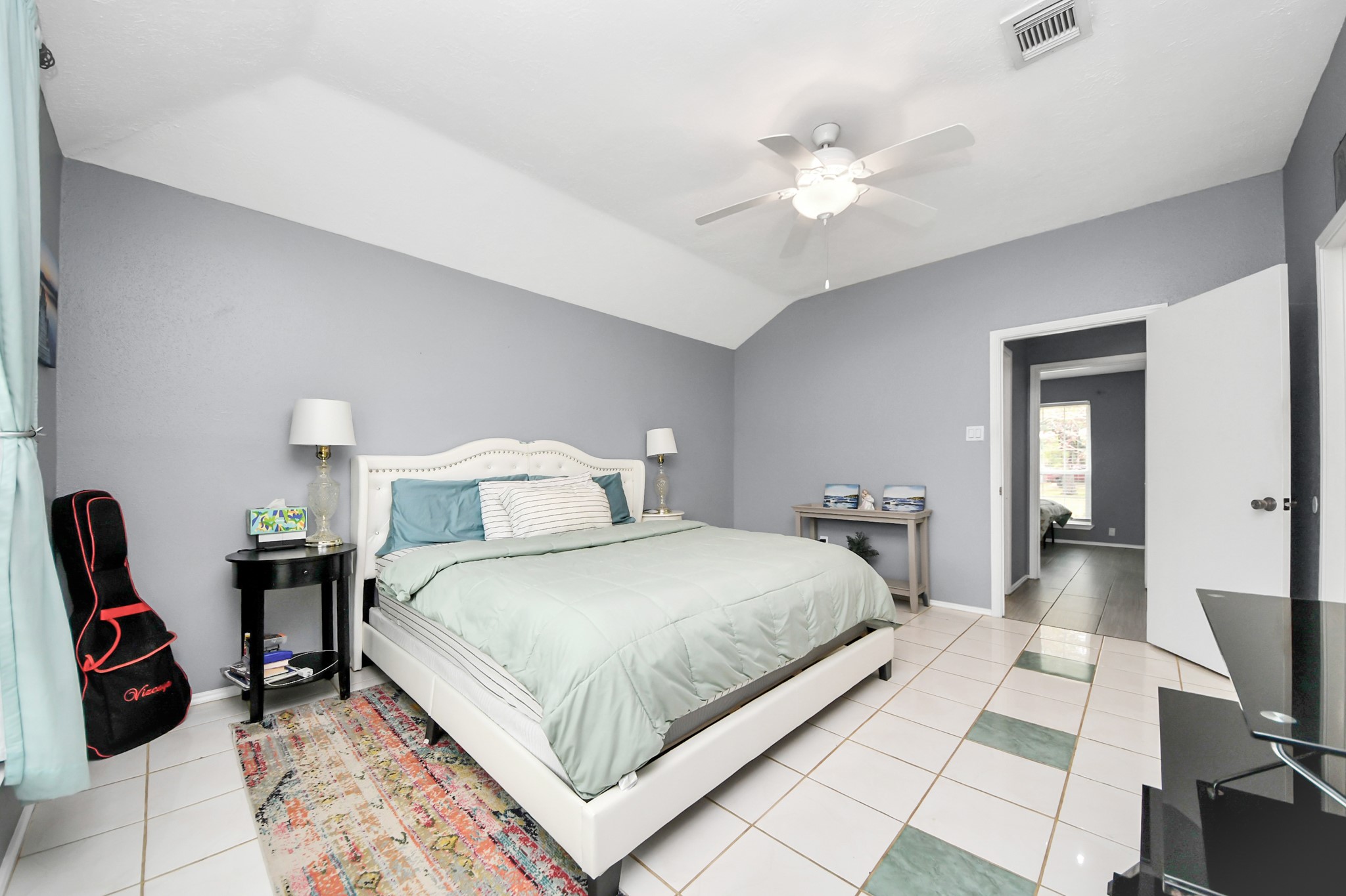 17702 Poppy Trails Lane Houston, TX 77084 - Photo 20 of 37 a bedroom with a bed and a chandelier