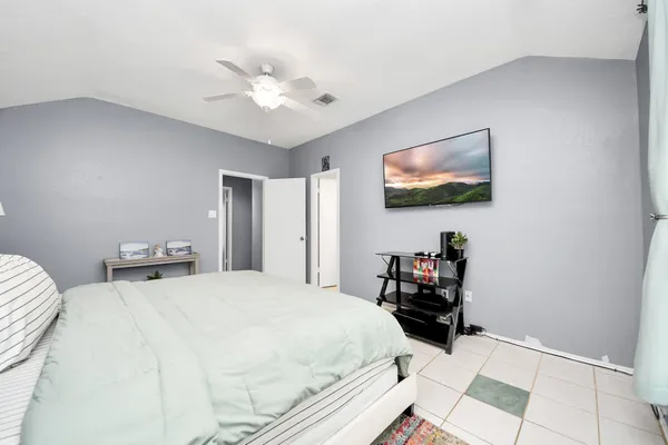 a bedroom with a bed and a chandelier
