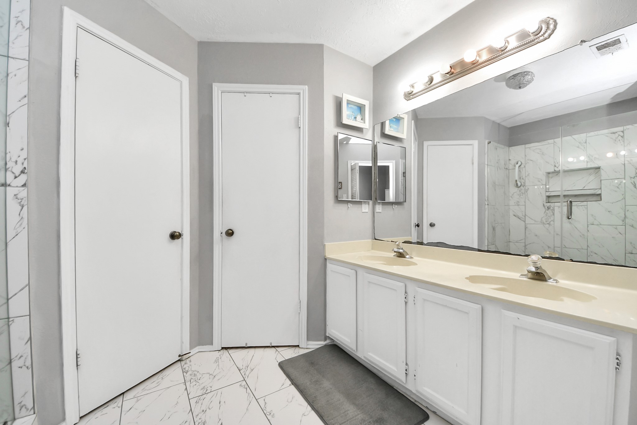 17702 Poppy Trails Lane Houston, TX 77084 - Photo 23 of 37 a bathroom with a double vanity sink and a mirror