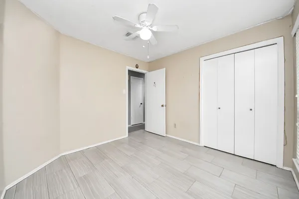 a view of an empty room with a ceiling fan