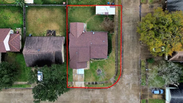 an aerial view of a house with outdoor space and a lake view