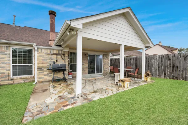 a view of a house with backyard porch and sitting area
