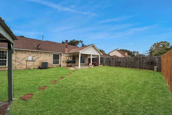 a front view of a house with yard and green space