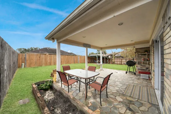 a view of a backyard with sitting area