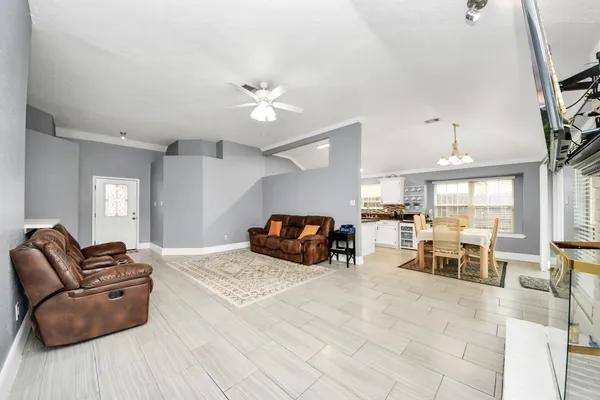 a large bedroom with a bed and furniture