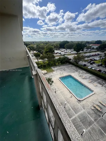 a view of swimming pool from a balcony