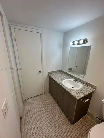 a view of kitchen island sink and refrigerator