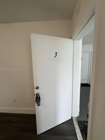 a view of storage and utility room with wooden floor