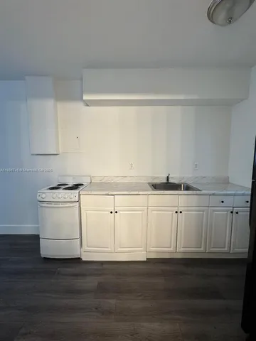 a view of cabinets and wooden floor