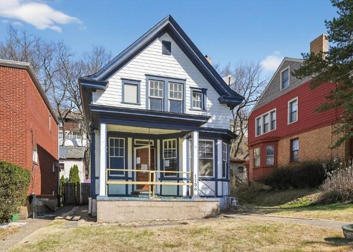 1156 Pemberton Street Pittsburgh, PA 15212 - Photo 1 of 20 a view of a brick house with large windows and couches chairs