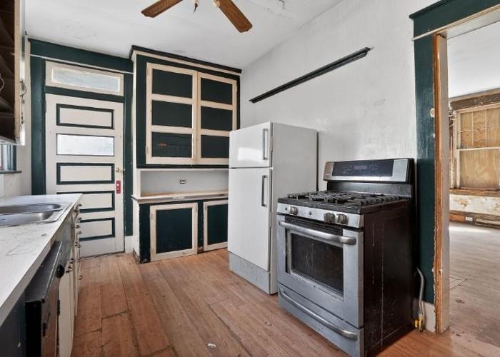 1156 Pemberton Street Pittsburgh, PA 15212 - Photo 12 of 20 a kitchen with granite countertop a stove and a refrigerator