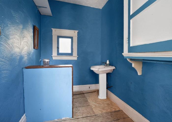 1156 Pemberton Street Pittsburgh, PA 15212 - Photo 20 of 20 a bathroom with a sink a mirror and a window