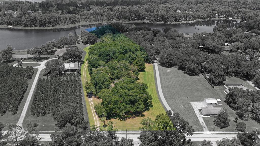 18302 Hanna Road Lutz, FL 33549 - Photo 2 of 58 an aerial view of a house with a yard and lake view