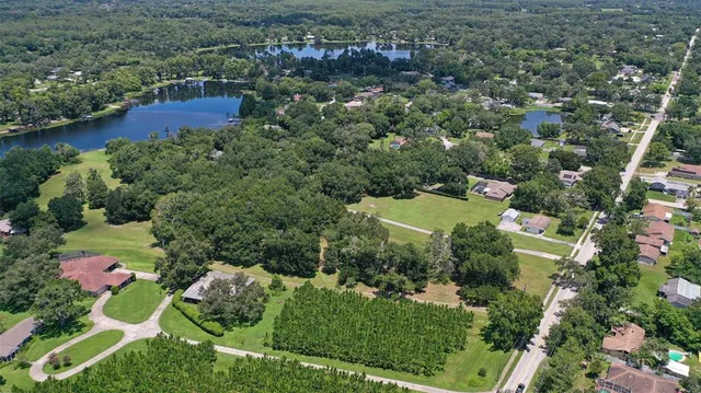 an aerial view of residential house with outdoor space and swimming pool