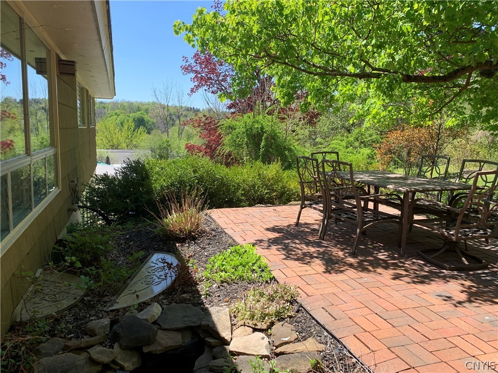 206 Deforest Road Syracuse, NY 13214 - Photo 40 of 49 Upper level brick patio with table and chairs