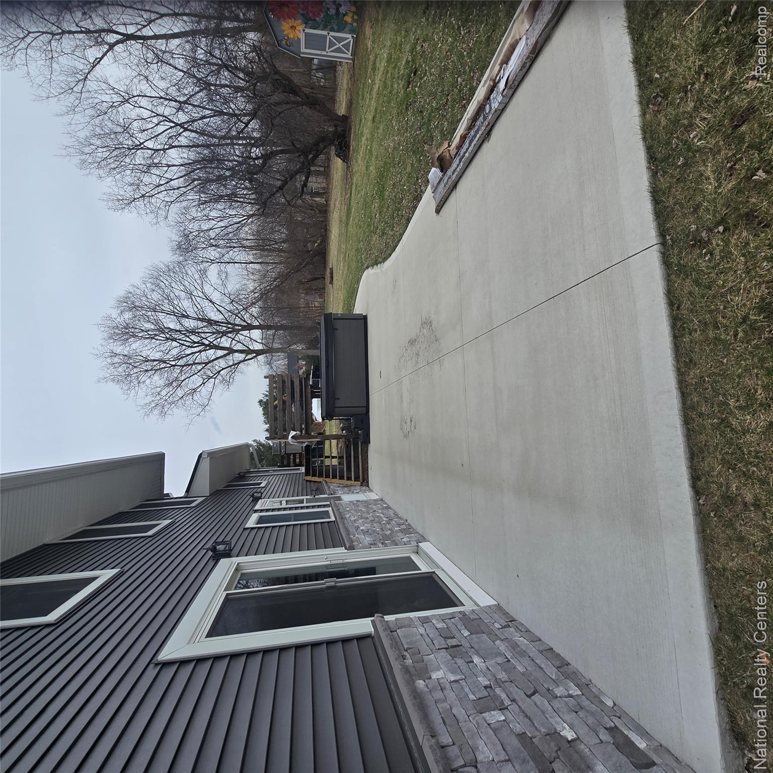 13477 South Horrell Road Fenton, MI 48430 - Photo 21 of 30 View of patio featuring a storage unit