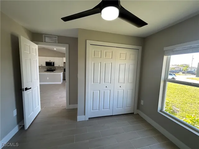 a view of a hallway with wooden floor and a cabinet