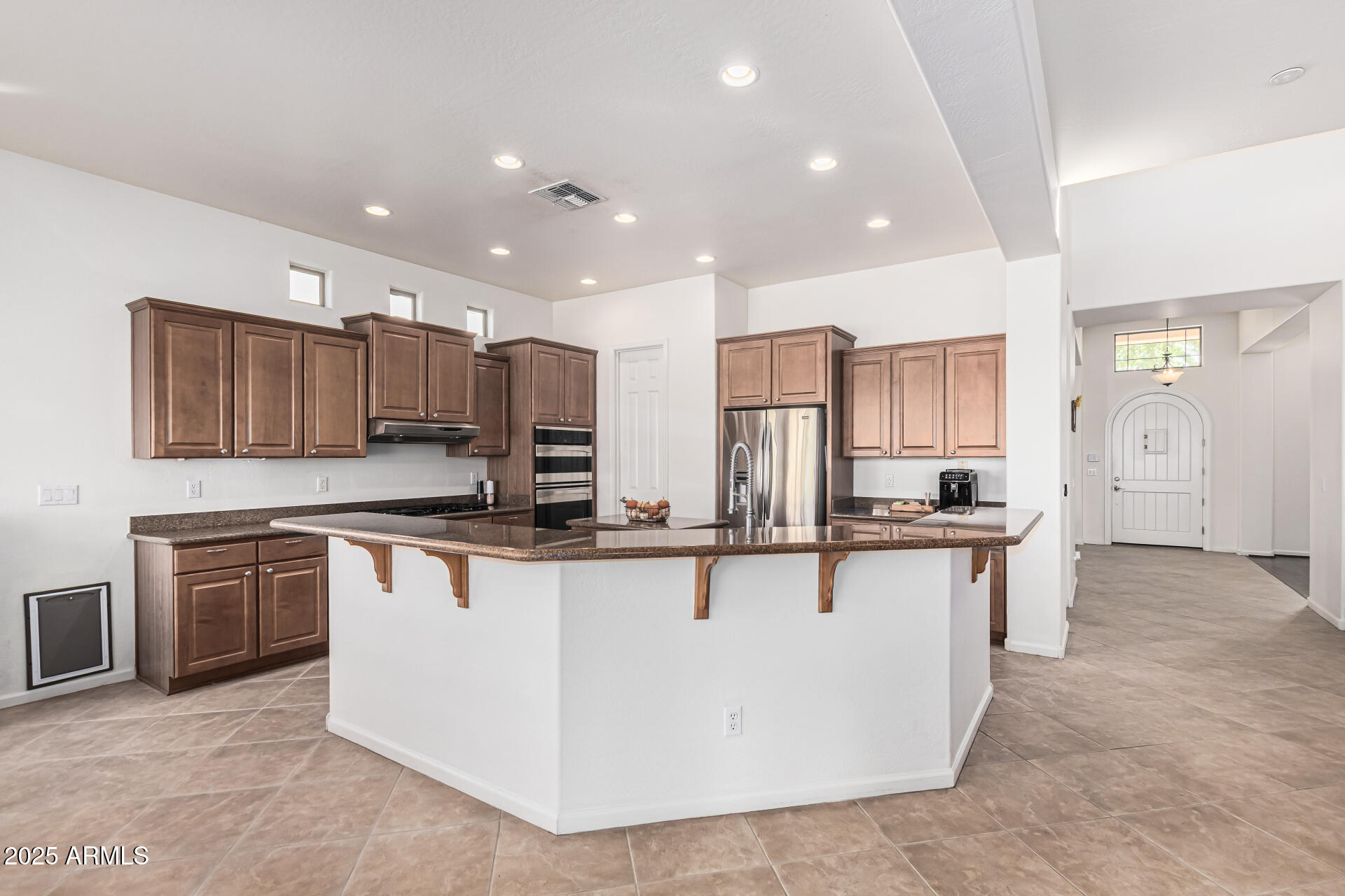 246 East Frances Lane Gilbert, AZ 85295 - Photo 7 of 25 a kitchen with stainless steel appliances granite countertop a stove top oven a sink and a refrigerator