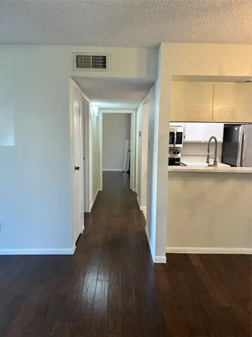 a view of a kitchen cabinets and wooden floor