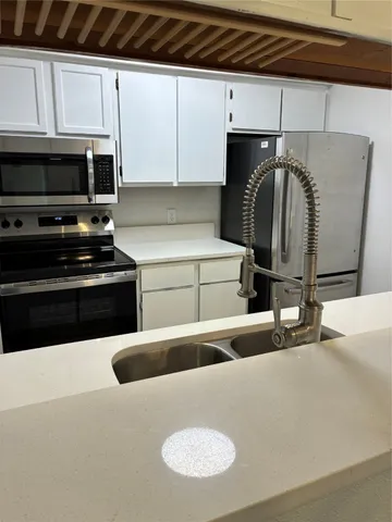a kitchen with a sink and a stove
