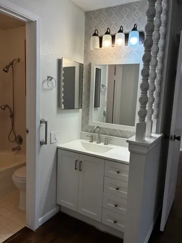 a bathroom with a double vanity sink mirror and