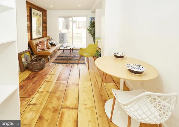 a living room with a bed and a table
