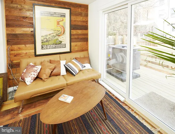 a view of a living room and a window with wooden floor