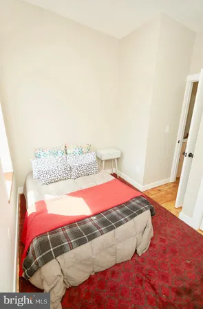 a bedroom with a bed and mirror
